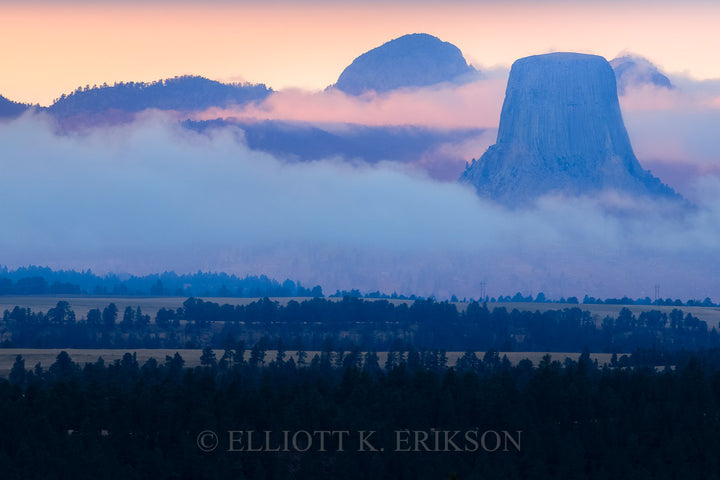 Devils Tower - Out of the Fog. Devils Tower appears out of the clouds at sunset.