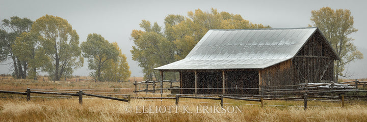 The Chill of an Early Fall. Autumn snow dusts roof of Mormon Row granary.