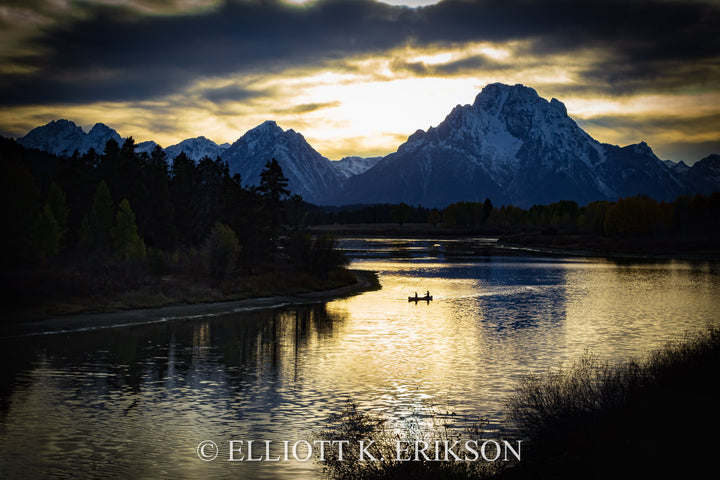 Just Around the River Bend. Silhouetted canoe at Oxbow Bend with sun setting behind Mount Moran.