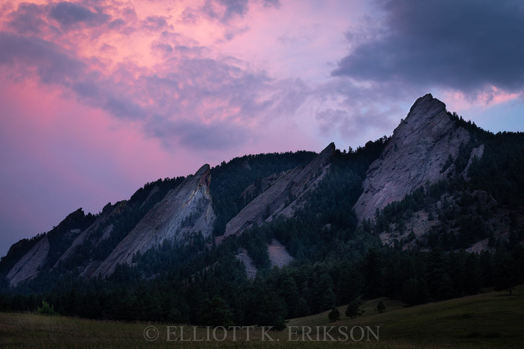 Colorado's Flatirons with a pink and purple sunset sky.
